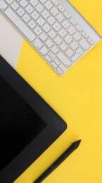 Ipad and keyboard on yellow desk